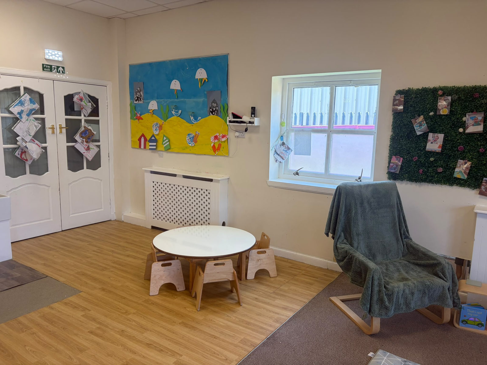 Under-the-sea display of the children's own artwork above the toddler table