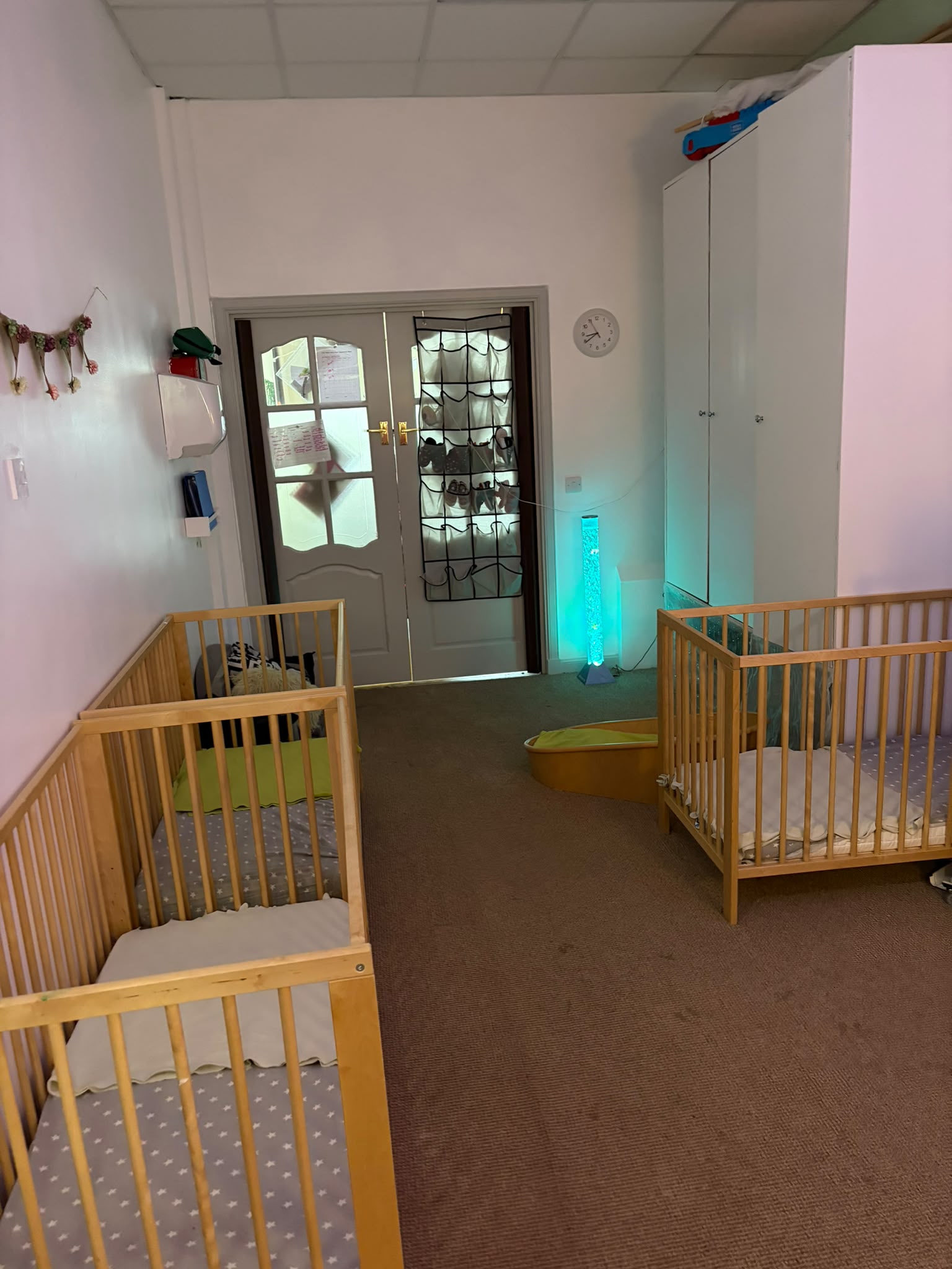 Calm sleep room with cots and a colour-changing sensory bubble tube