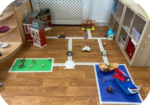 Small world roadway with dolls house, vehicles and play mats